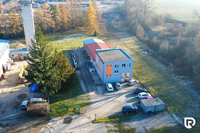 Production facilities on Továrenská Street in Dubnica nad Váhom surrounded by greenery and cars.