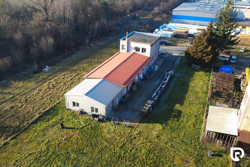 Production premises on Továrenská in Dubnica nad Váhom surrounded by greenery and other buildings.