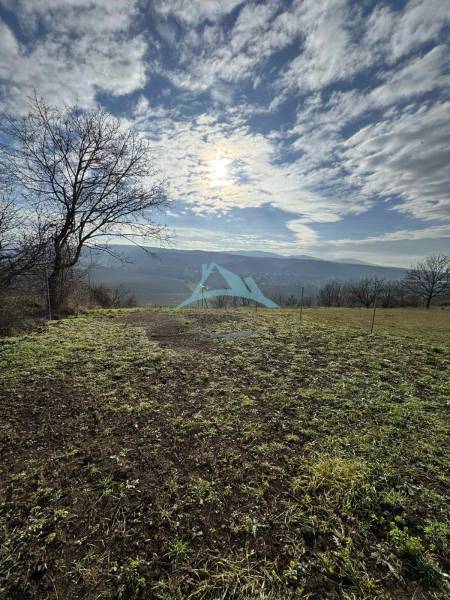 A panoramic view from the cottage in Šahy of the vast hills and cloudy sky.