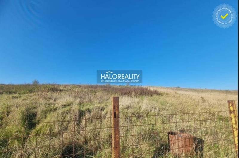 A grassy plot in Partizánske, suitable for living, with a blue sky.