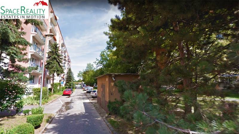 A view of Medzilaborecká Street in Bratislava - Ružinov with buildings and greenery.