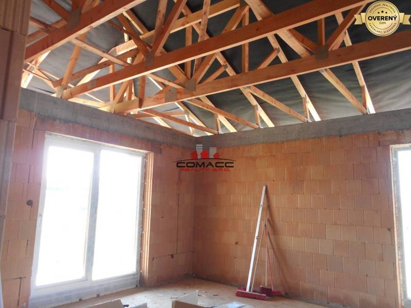 Under-construction interior of a family house on Nové Mesto nad Váhom street with a wooden roof structure.