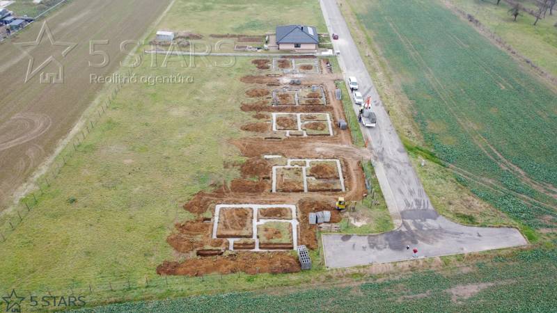 Construction of a family house on the street in Štvrtok, view of the building foundations and surroundings.