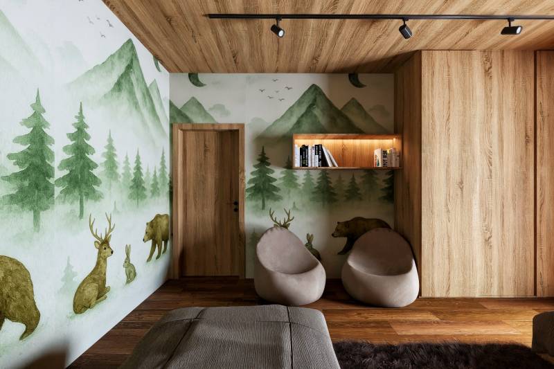 Interior with a wall mural of a forest, seating, and wood-patterned flooring for home construction.