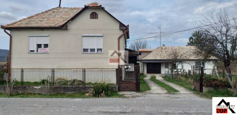 Family house in Studená with a front garden, garage, and a lawn. The house is for sale.