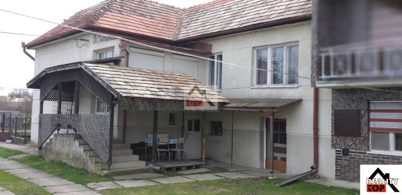 A family house in Studená with a covered terrace and a tiled roof.