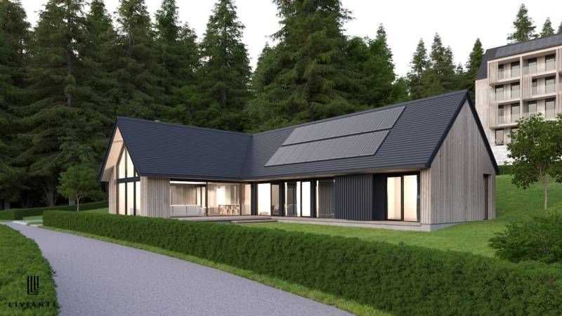 A wooden house with a modern design is located among the forests near the developer plots in Tajov.
