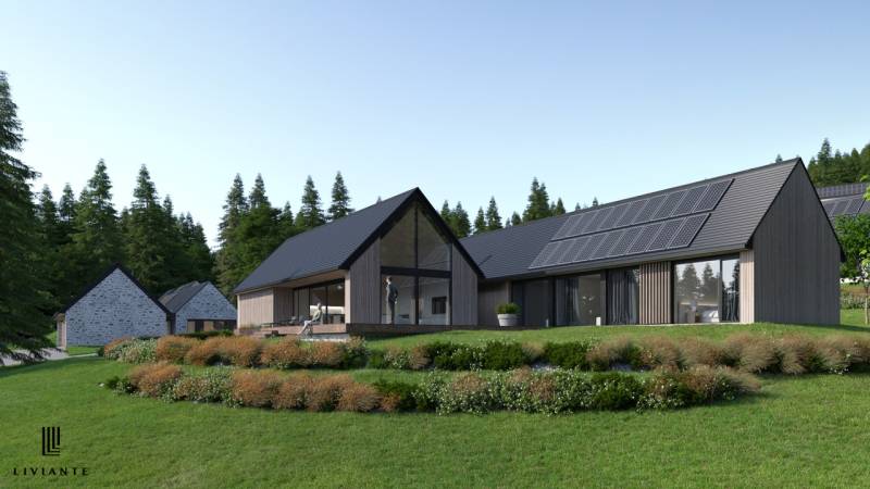 Development plots in Tajov with modern houses surrounded by greenery and forests.