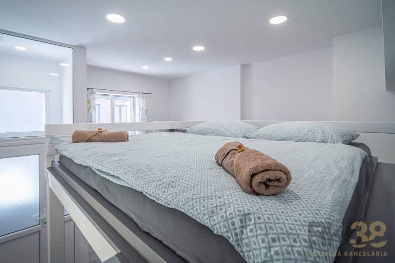 A bright bedroom with a comfortable bed, softly coordinated textiles, a window facing Hviezdoslavova Street.