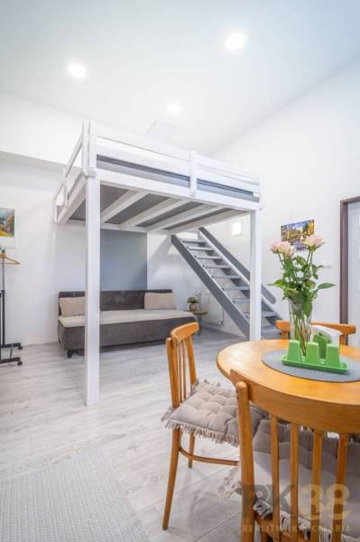 Interior with wooden furniture and a raised bed on Hviezdoslavova Street, suitable for a 4-room apartment.