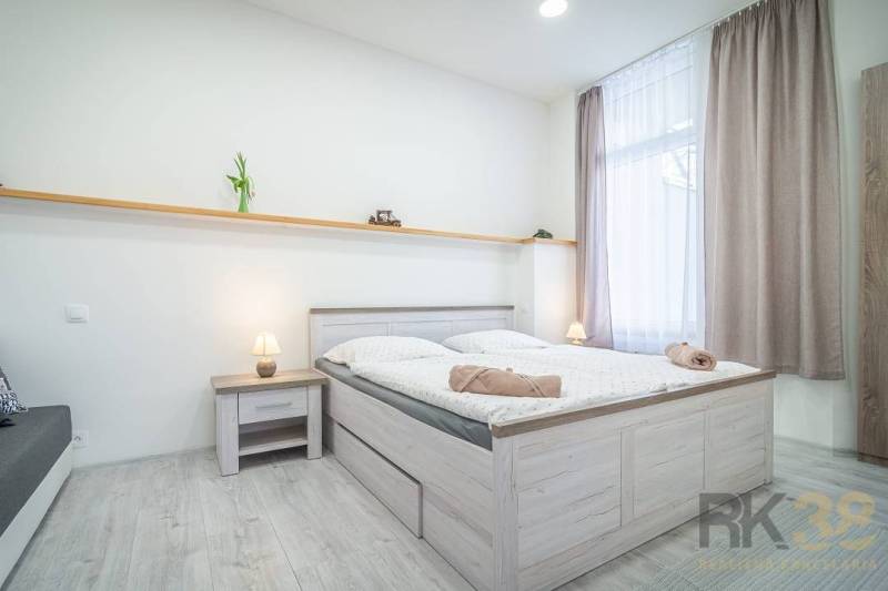 Bright 4-bedroom with a bed and a nightstand on Hviezdoslavova Street.