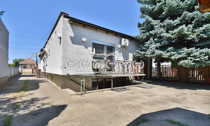 A family house on Hlavná Street in Zavar with a spacious yard and a large tree.