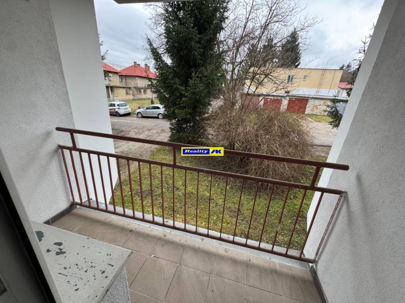 A balcony in a 2-room apartment on Mládeže in Martin with a view of greenery and a parking lot.