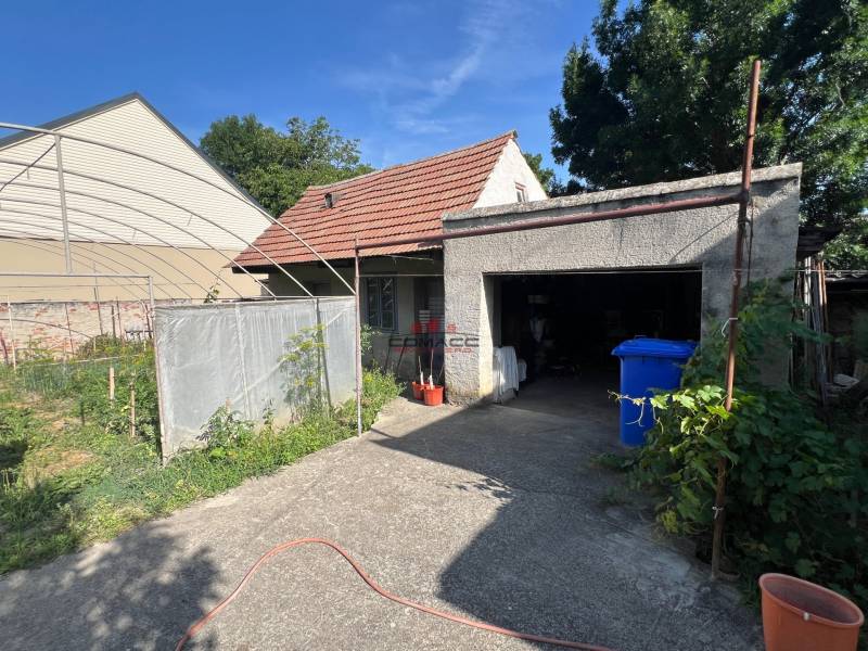 Family house in Drahovce on Drahovce street with a carport and garden.