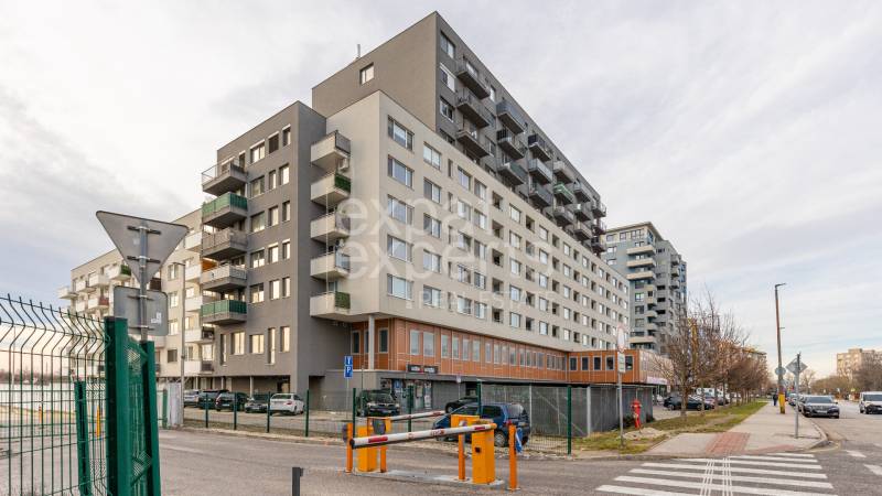 Apartment building on Budatínska Street in Bratislava - Petržalka, with parking and shops.