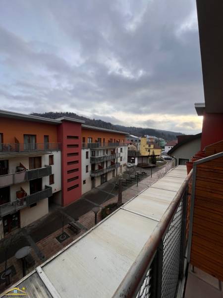 View from the balcony of a holiday apartment in Oščadnica overlooking residential buildings.