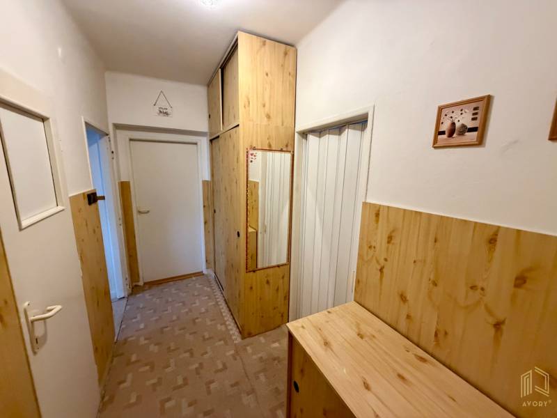 Interior of a 3-room apartment with built-in wardrobes and flooring with a wood decor.