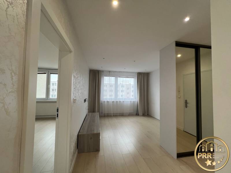 A bright room with a wooden decor floor in a 3-room apartment.