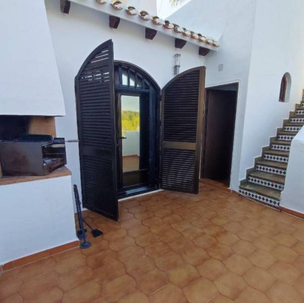 Family house in Villa Martin with a terrace, entrance doors, and a grill.