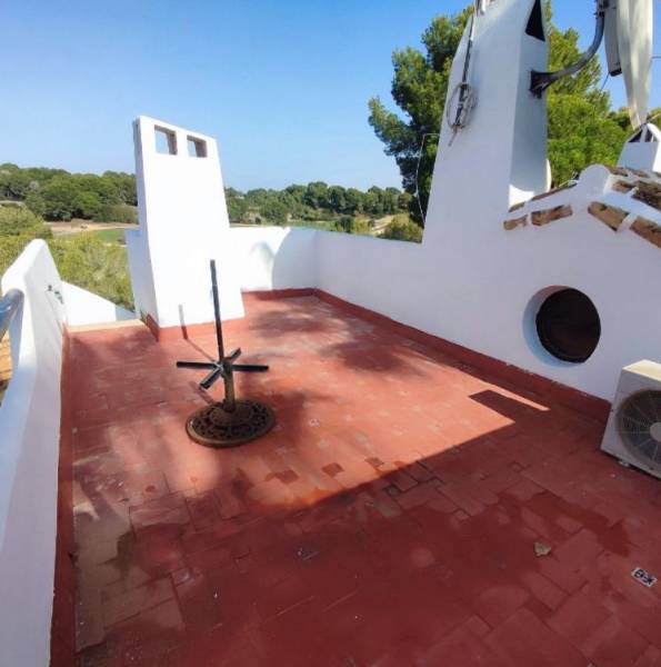Terrace of a family house in Orihuela Costa with a view and a red floor.