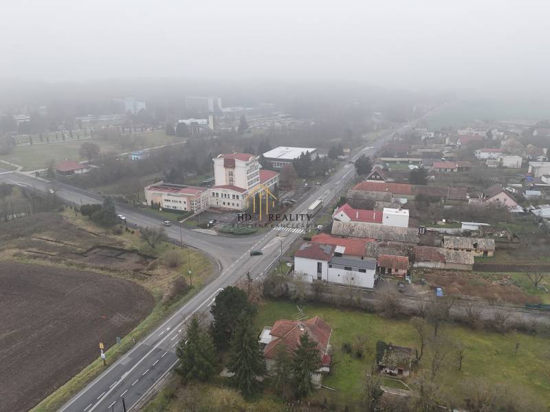 Aerial view of commercial land in Dudince in foggy weather.