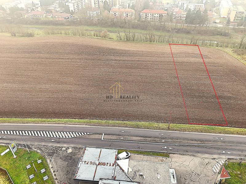 Aerial view of a commercial plot in Dudince, with the parcel marked by the main road.