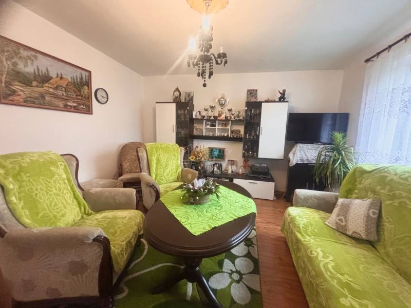 A living room in a family house with furniture and flooring featuring a wooden decor.