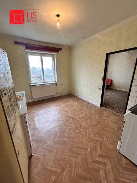 A kitchen with a wood-patterned floor in a family house.
