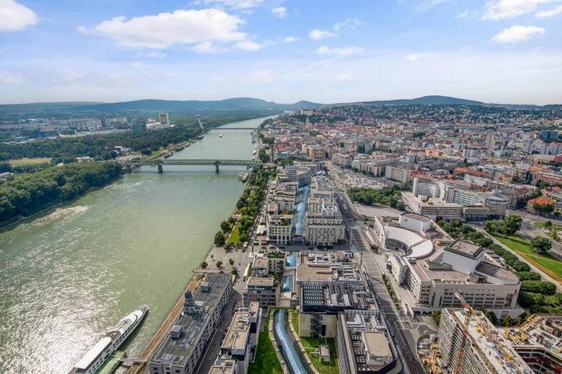 Aerial view of Bratislava across the river with a view of Pribinova and city architecture.