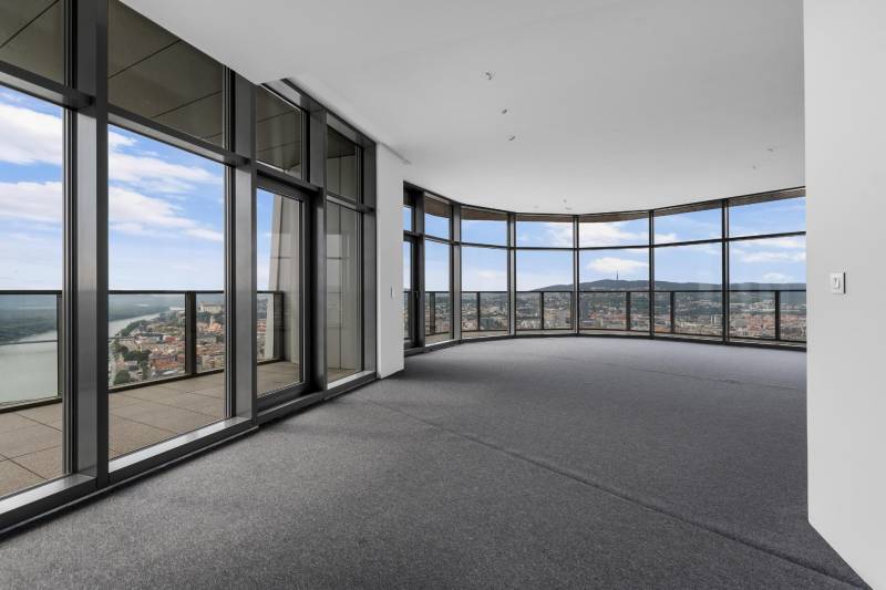 Spacious living room with glass walls and a view within a 4-room apartment.