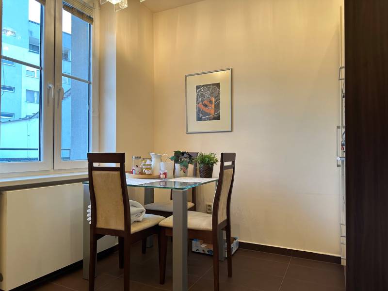 Dining area with two chairs and a table in a 2-room apartment.