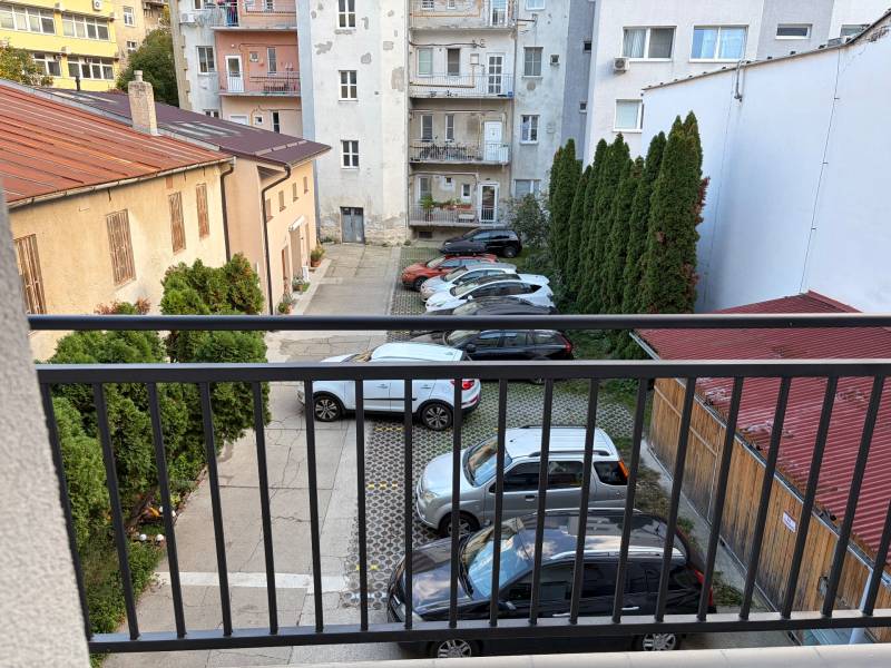 Parking lot with cars and greenery on Cukrová Street in Bratislava - Old Town.