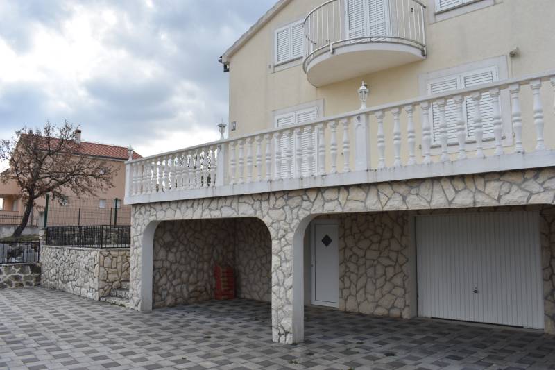 A family house in Pridraga with a stone facade, large terrace, and garage.