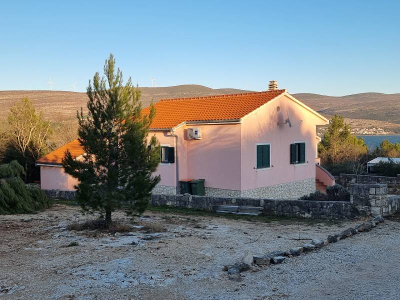 A family house in Pridraga near the coast, surrounded by nature and countryside with wind turbines.