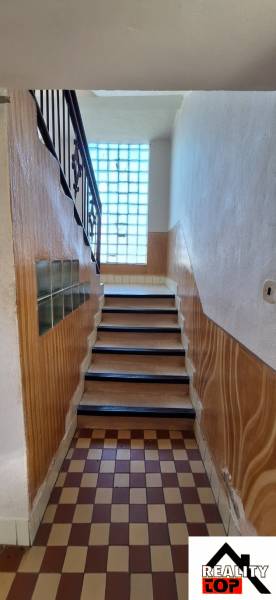 A staircase with a tiled floor in a family house.