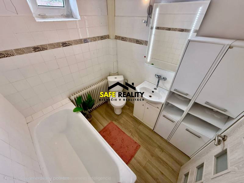 A bathroom in a family house with a wooden decor floor, a sink, and a bathtub.