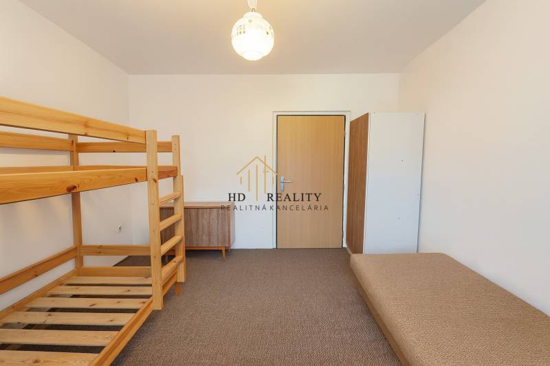 A bedroom in a 3-room apartment with a bunk bed and a sofa, neutral design.