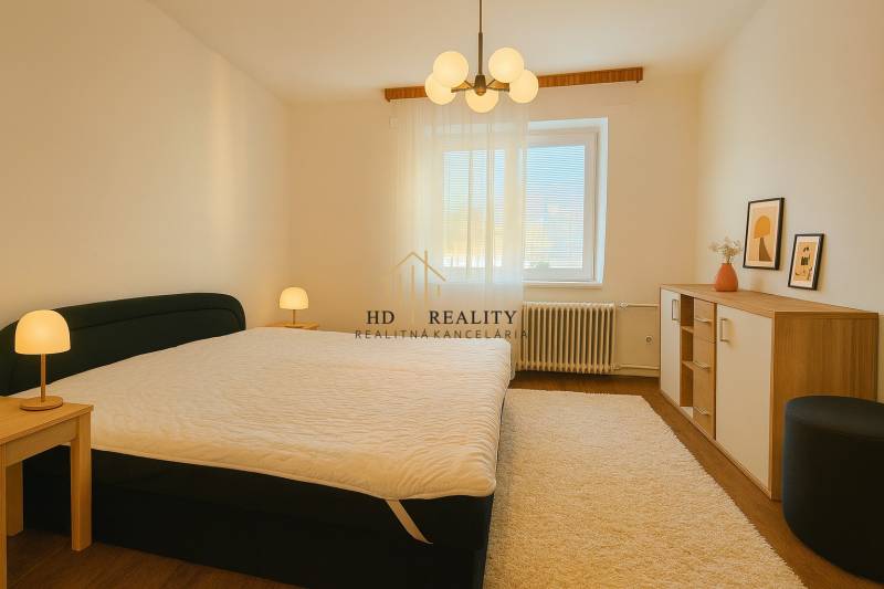 Bedroom in a 3-room apartment with a bed, lamp, and carpet flooring with a wooden decor.