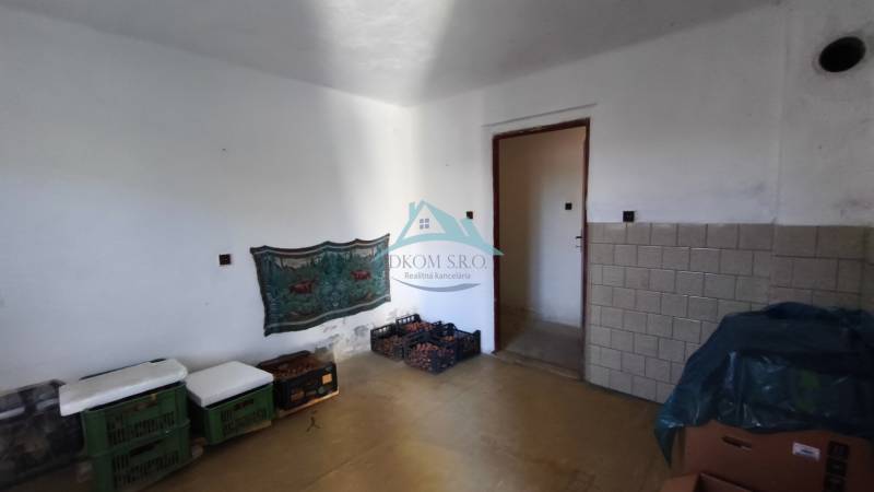 A room in a family house with white walls and storage in plastic crates.