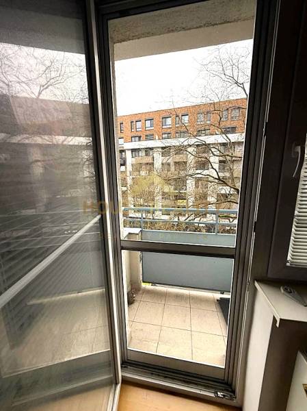 4-room apartment with a balcony and a view of the neighboring building.