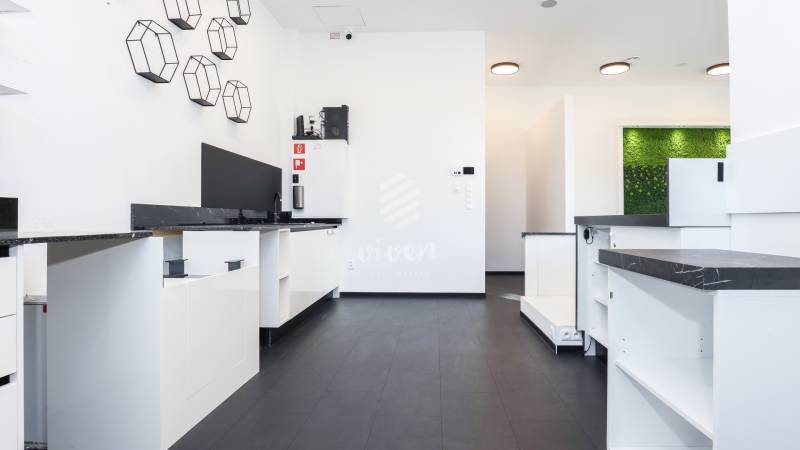 Commercial spaces with black countertops, decorative walls, and geometric elements.