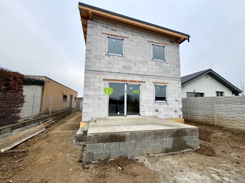 An unfinished family house in Čaňa on Hviezdna Street, with a concrete terrace.