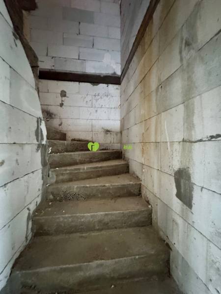 Concrete staircase and block walls in a family house.