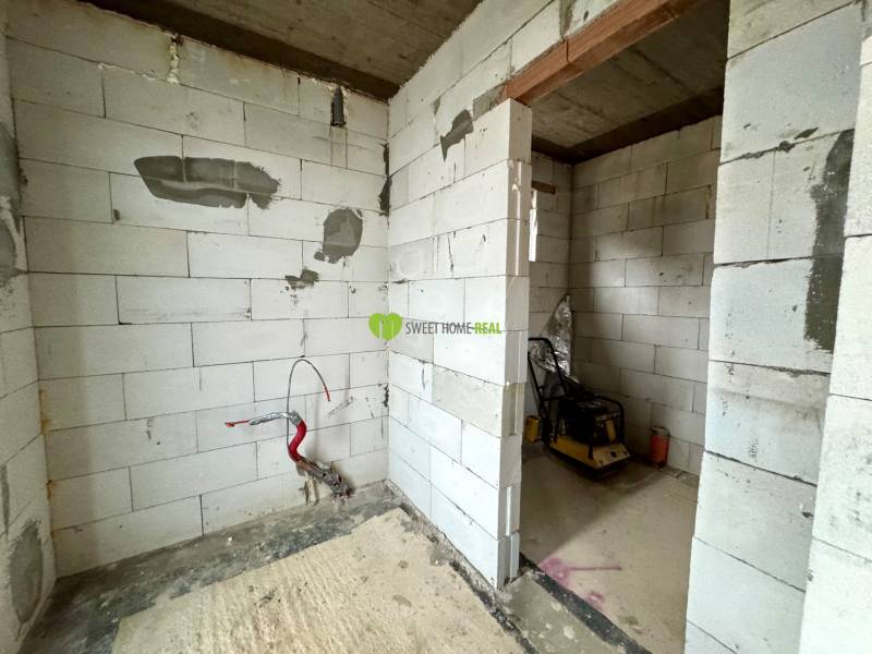 A building in a family house with unfinished walls and electrical wiring.