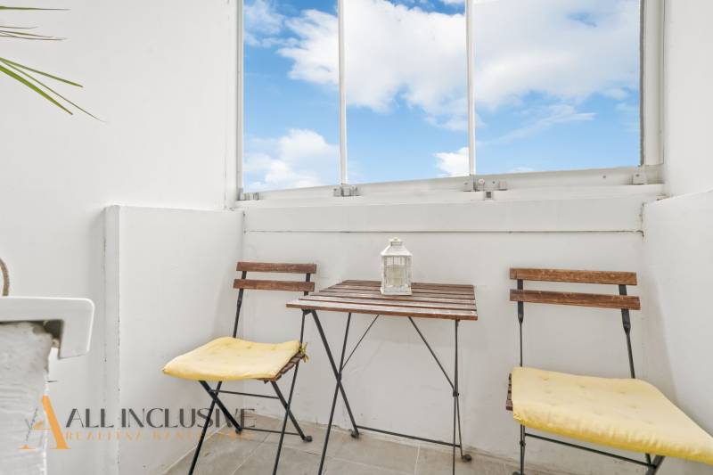 A balcony with folding furniture and a lantern in a 3-room apartment.