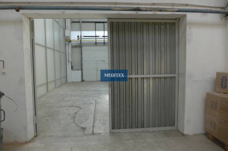 Warehouses and halls with concrete floors and metal doors in the interior.
