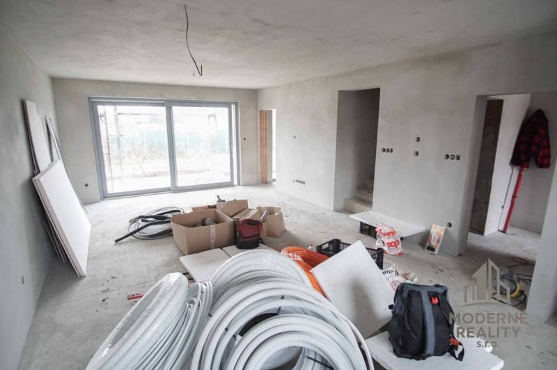 A construction project in a family house with a view of the terrace. Minimalist interior and preparation of electrical installation.