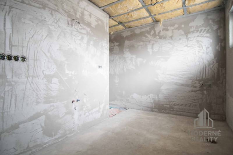 The interior construction of a family house with unfinished plastering and insulation.