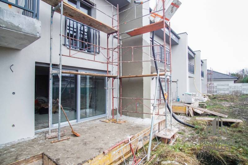 A family house in Nové Zámky during renovation, scaffolding by the entrance door.