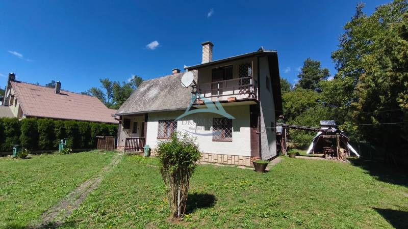 A cottage in Dolné Strháre with a large garden and a satellite dish on the roof.